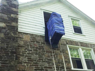 Armoire being lowered from a 3rd story window