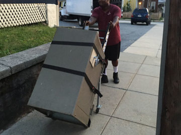 Crew member transporting a safe