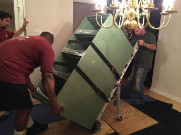 Crew members installing a cabinet