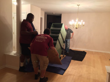 Crew members installing a cabinet