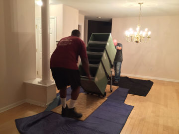 Crew members installing a cabinet