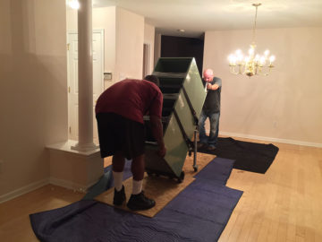 Crew members installing a cabinet