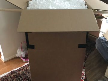 Once our box is filled to the brim with packaging, we are ready to seal.