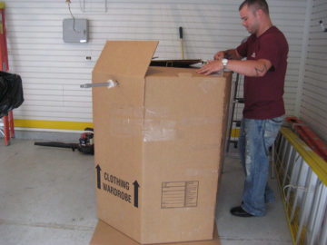 There is an art to packing boxes. Here our mover assembles a waredrobe box to easily transport hanging clothing.