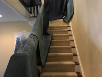 Moving around awkward corners can be tricky. We use blankets to protect areas like stairways.