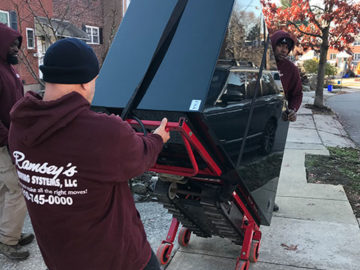 Two of our men move the the safe along the street while our other team member helps direct them.