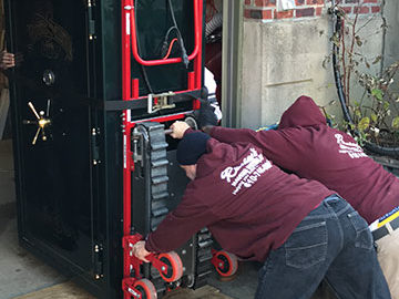 Our team uses flexible planks to help maneuver the safe onto wheels.