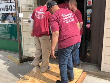 It takes an entire crew to safely move the vault door out of the building.