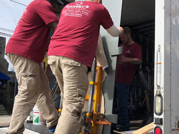 Our crew communicates while loading the door onto the truck.