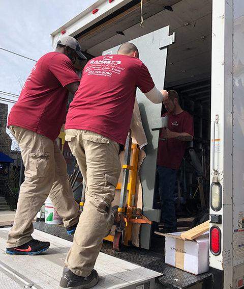 Our crew communicates while loading the door onto the truck.