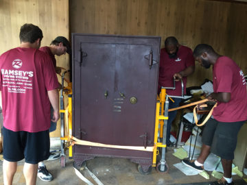 Our crew preps the safe by securing it on wheels.