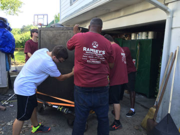 Now that the safe has made it off the truck, the moving team can begin to navigate the safe into its new space.