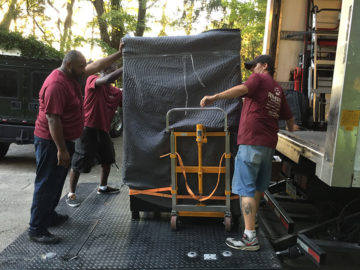 The team lowers the safe onto the ground of it's new destination!