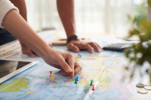 couple looking at destinations on map for long distance move