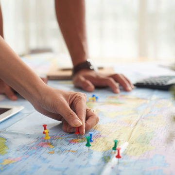 couple looking at destinations on map for long distance move